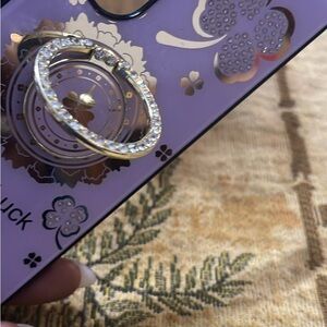 Purple and gold luck clovers basic phone case with a kick stand.